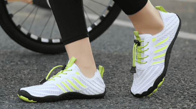 Person wearing white and neon green barefoot shoes